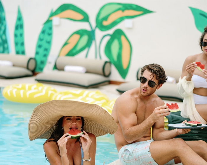 group of people enjoying food next to a pool