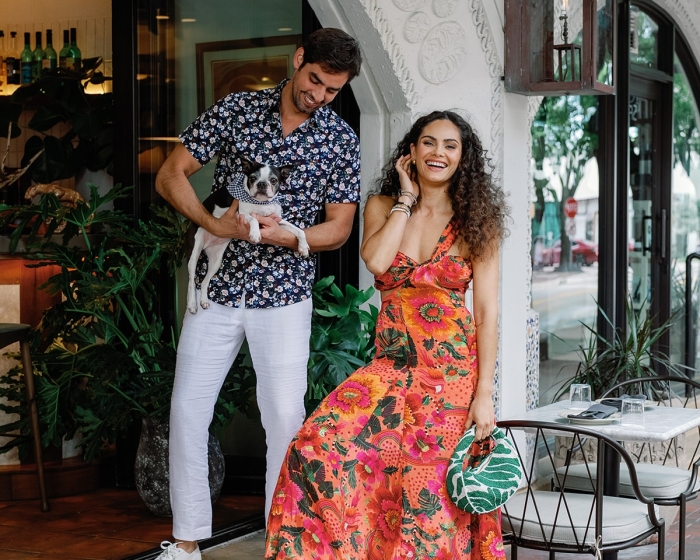 two people holding a dog