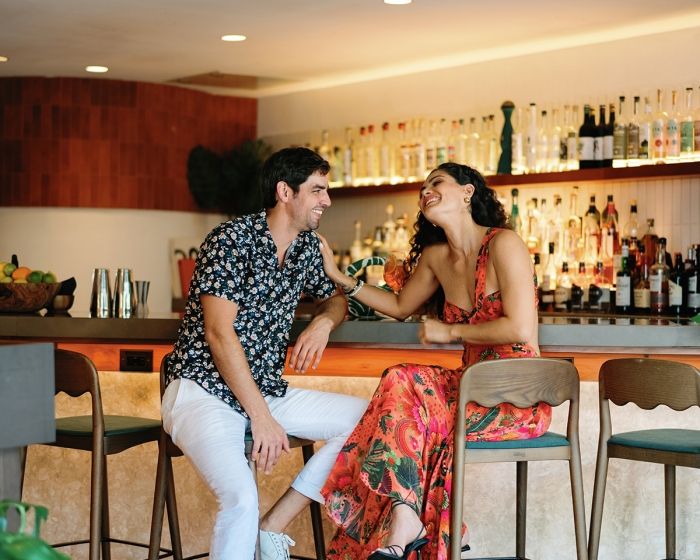 two people sitting at a bar