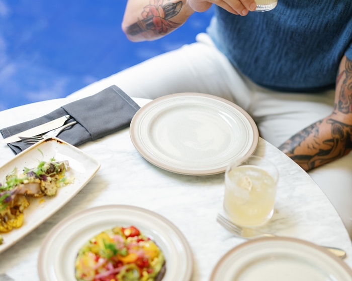 a man drinking at a table