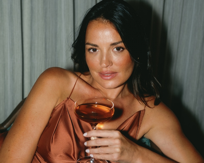 a woman holding a drink