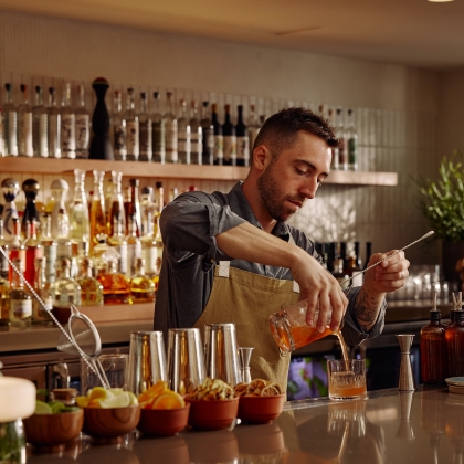 a bartender pouring a drink
