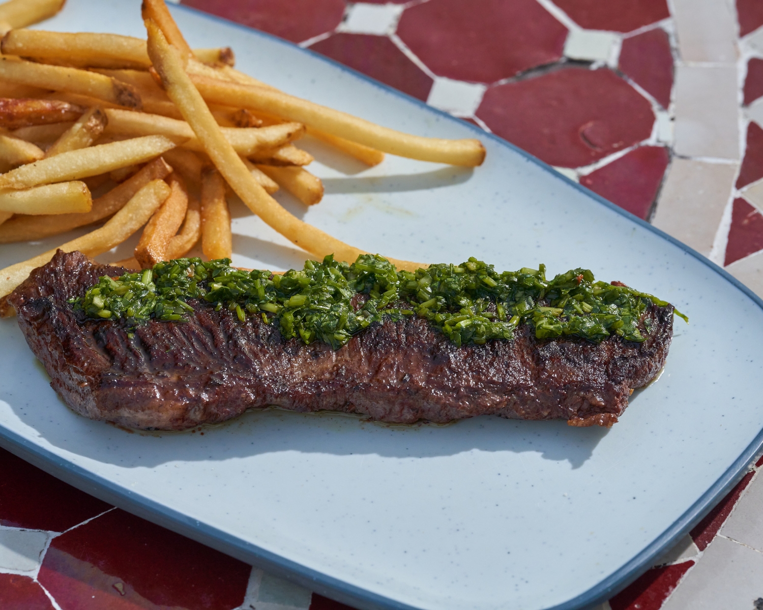 Steak with garnish and fries
